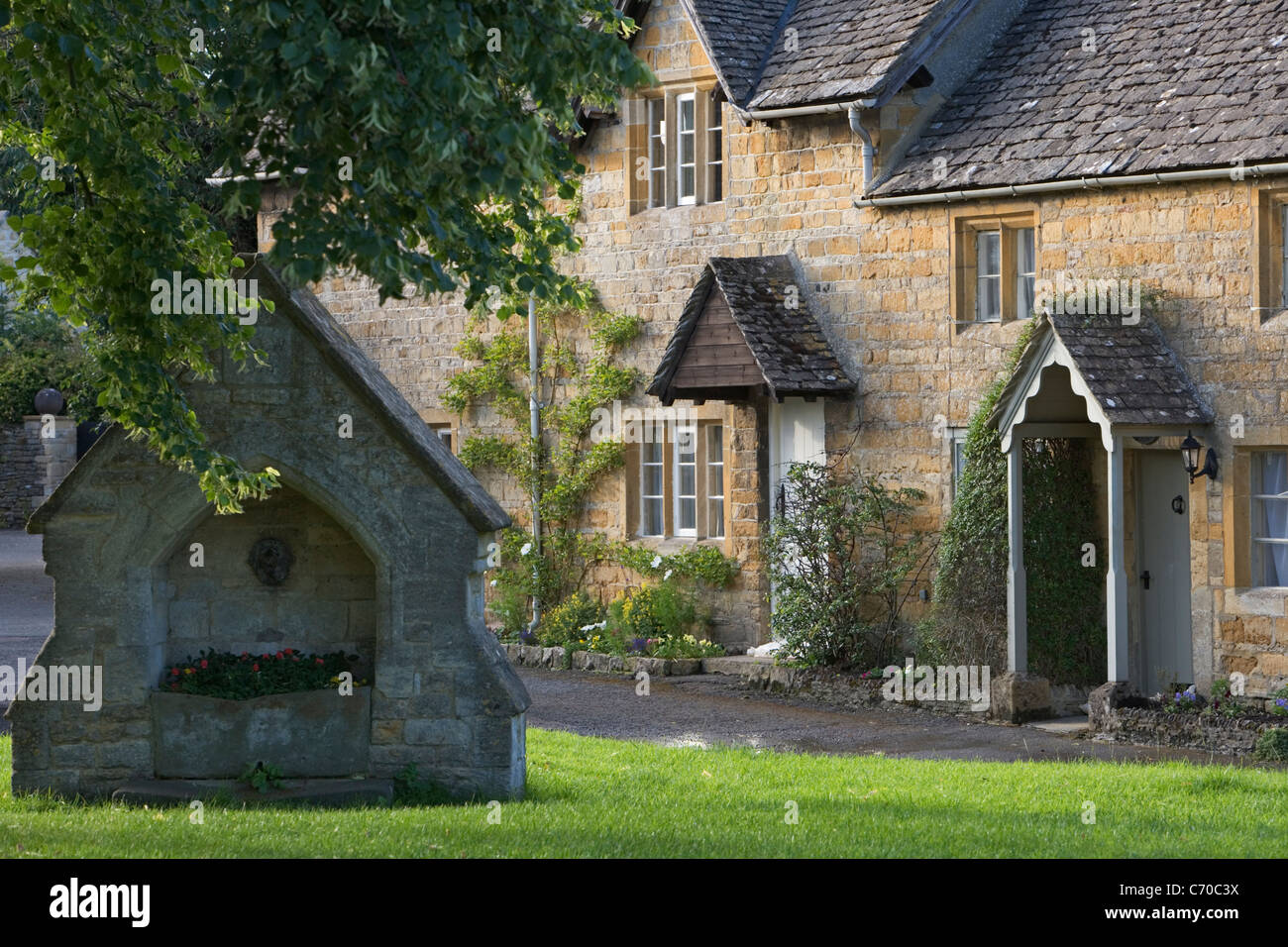 Well and village houses in the cotswold village of Lower Slaughter