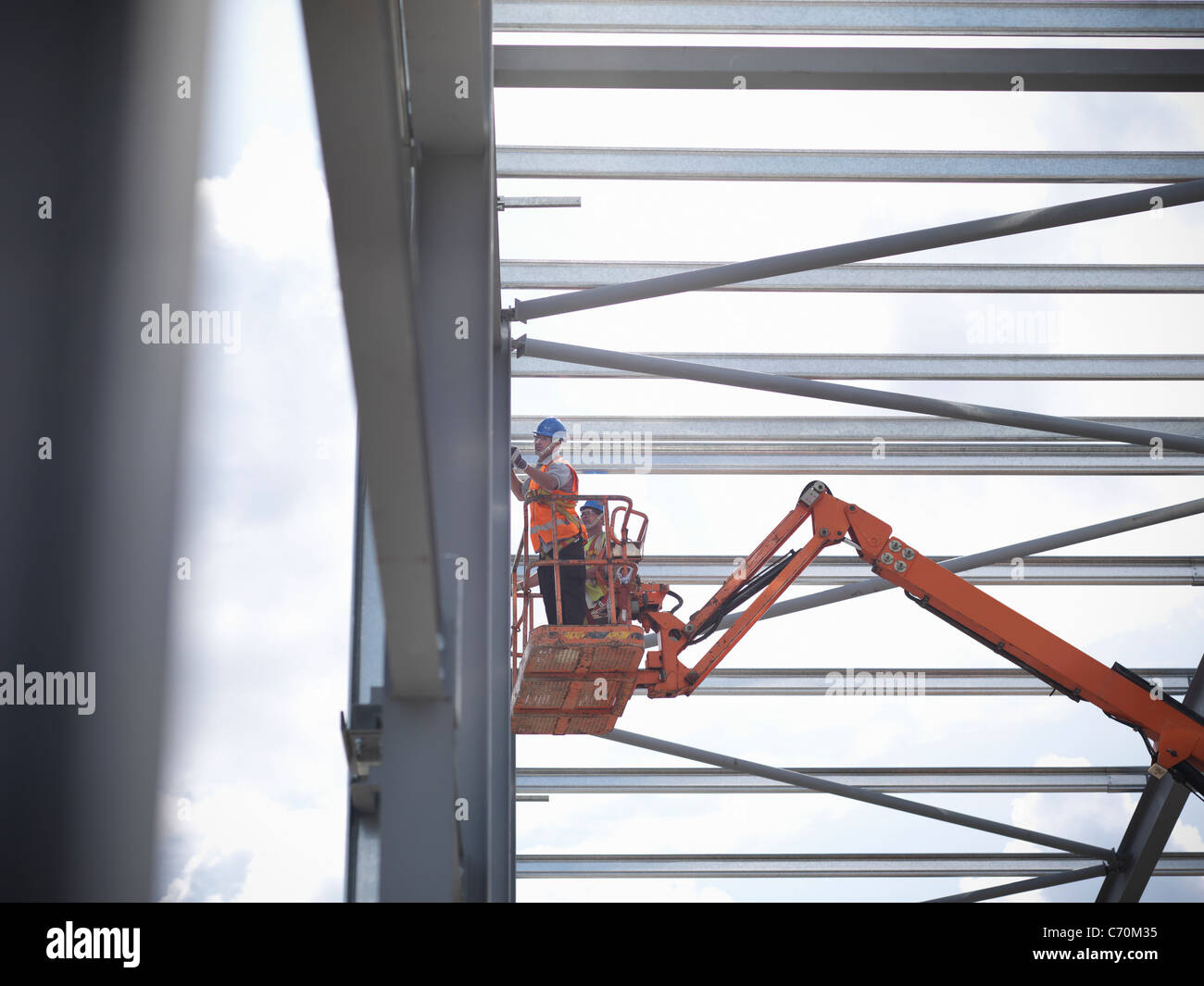 Construction workers in cherry picker Stock Photo