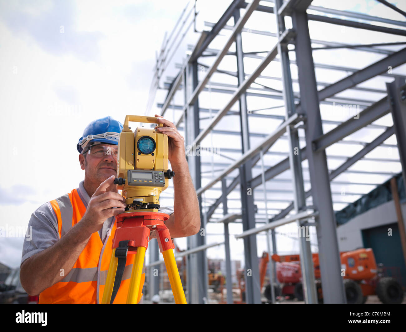 Construction worker surveying site Stock Photo