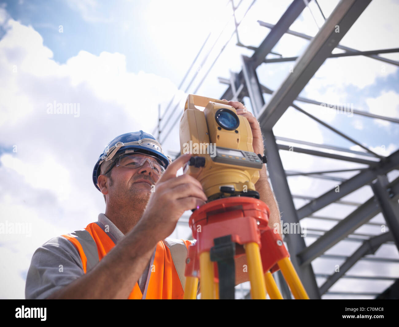 Construction worker surveying site Stock Photo