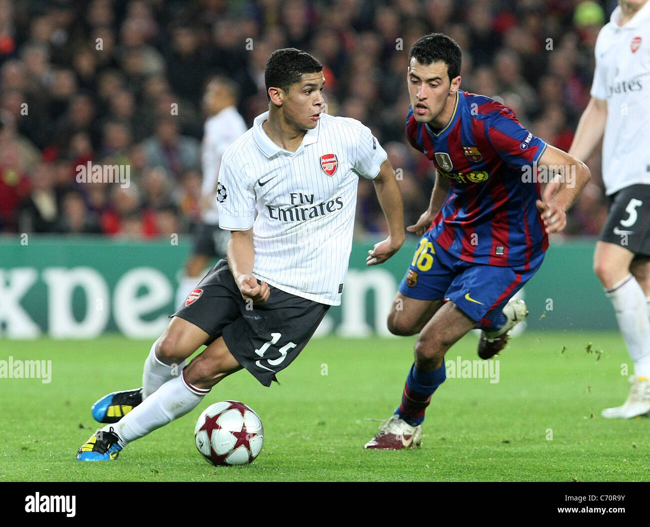 Arsenal's Denilson (l) and FC Barcelona's Sergio Busquets during the