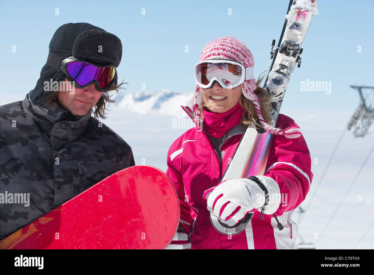 Skiers carrying equipment outdoors Stock Photo
