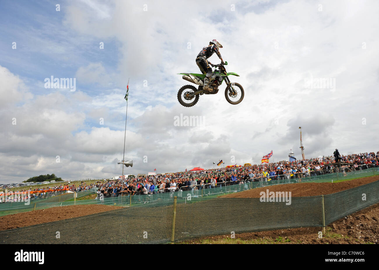 A Motocross Rider jumps through the air on an MX Bike Stock Photo Alamy