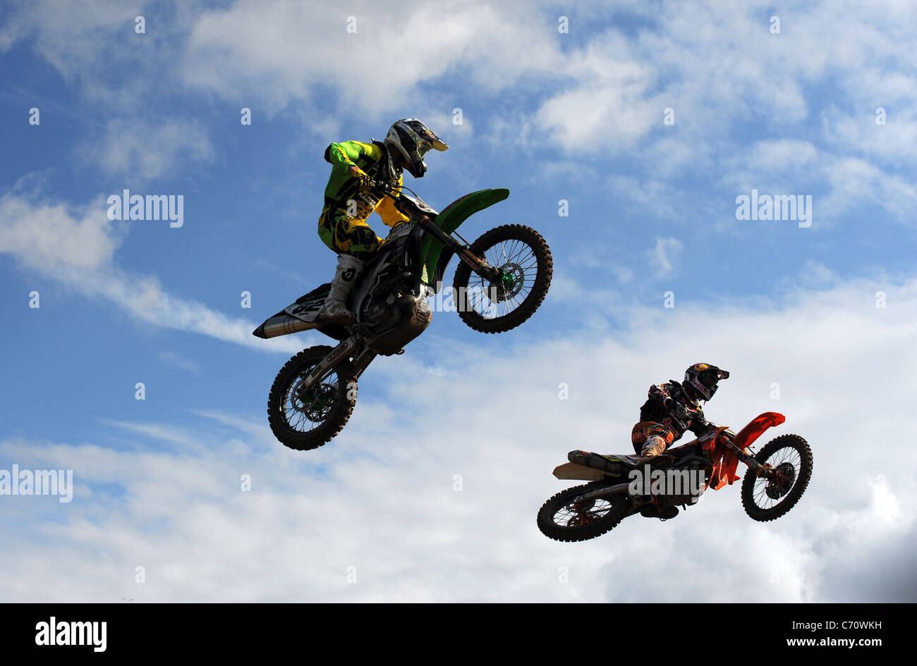 Motocross Racers jumping on MX Bikes Stock Photo Alamy