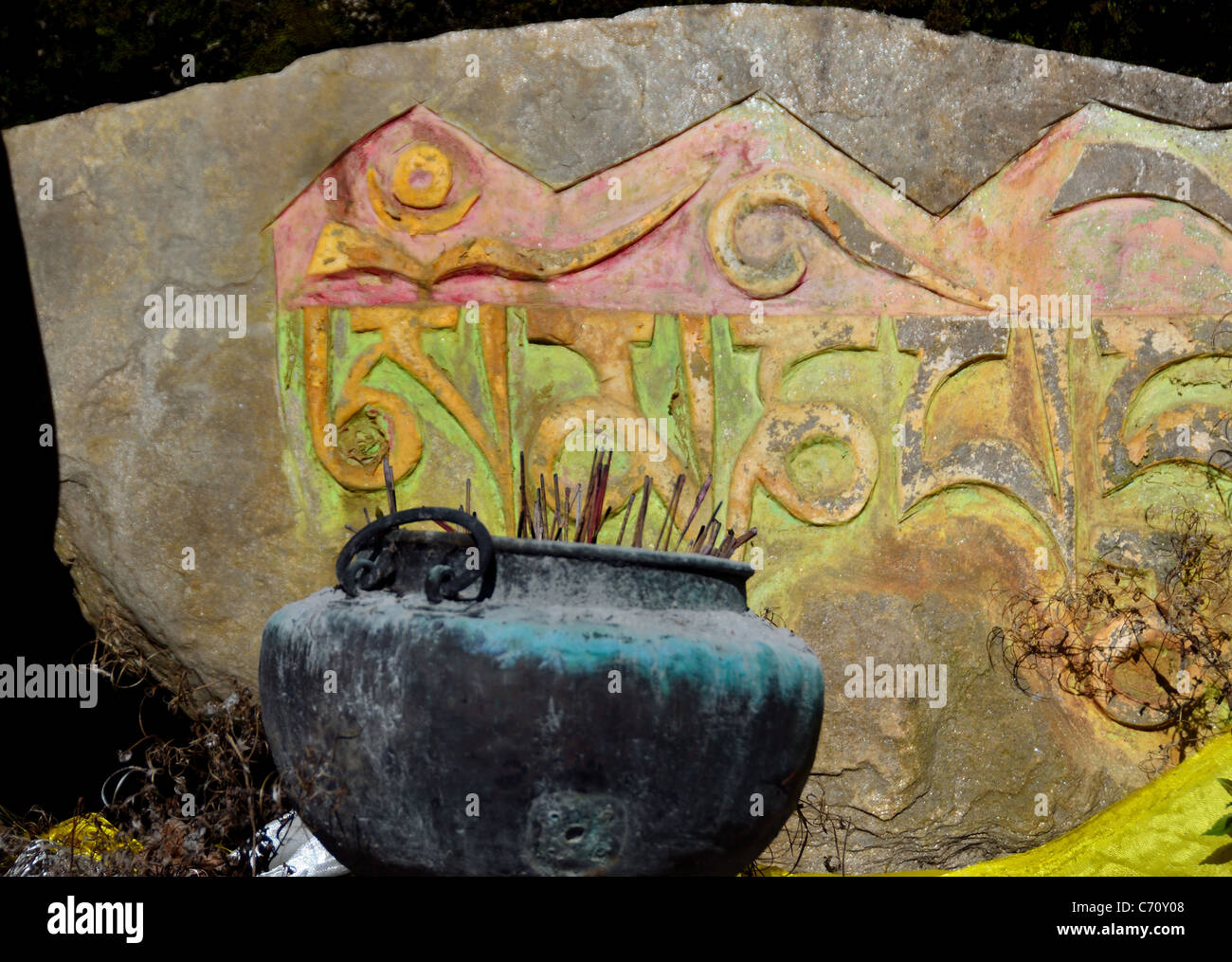 Incenses burning in a pot in front of carved Tibetan stone tablet. Sichuan, China. Stock Photo