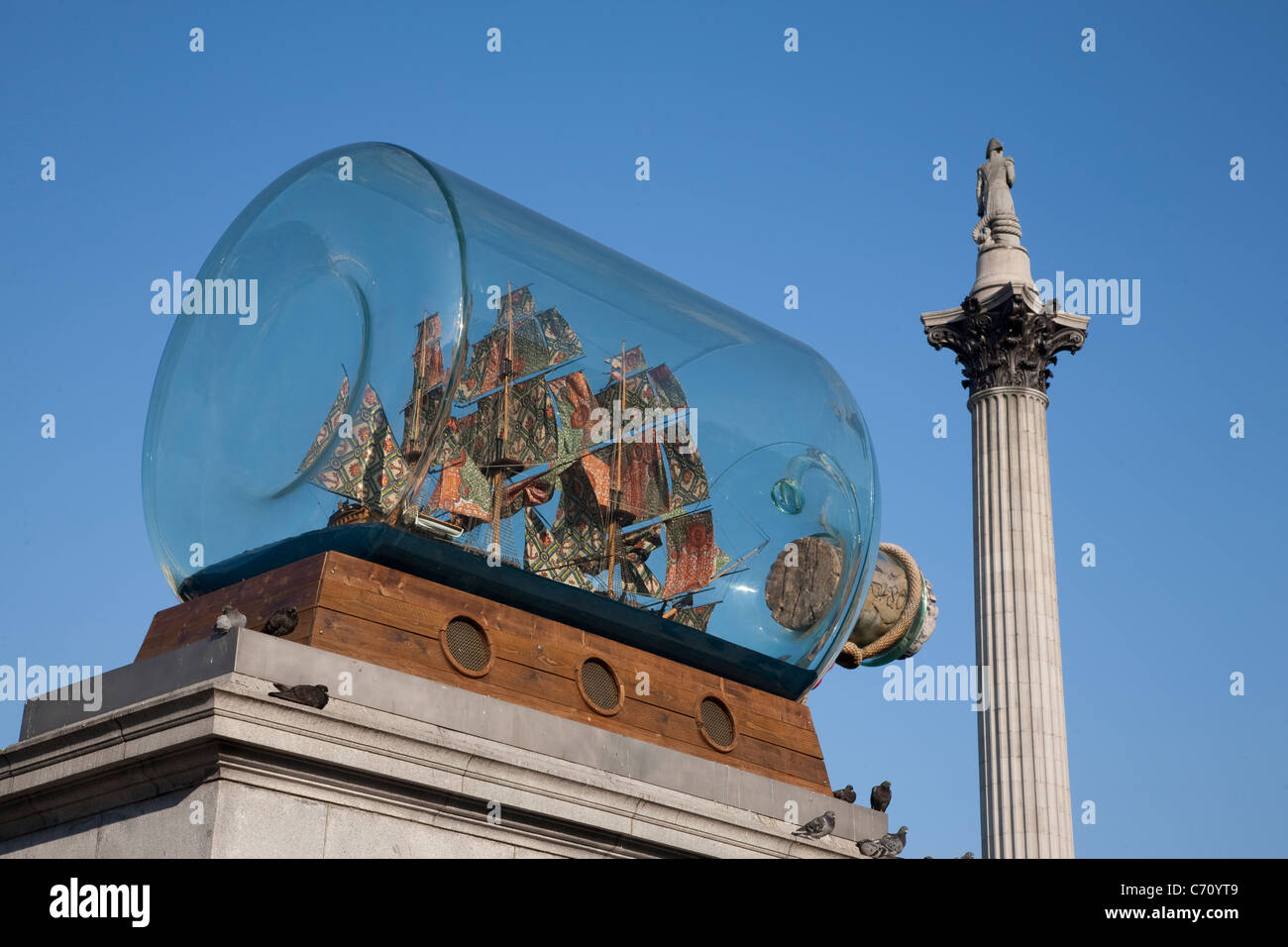 Nelsons Ship in a Bottle by Yinka Shonibare with Nelsons Column in background, Trafalgar Square, London, England, UK Stock Photo