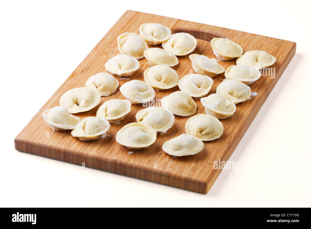 Background from russian crude pelmeni laid out on a chopping board Stock Photo