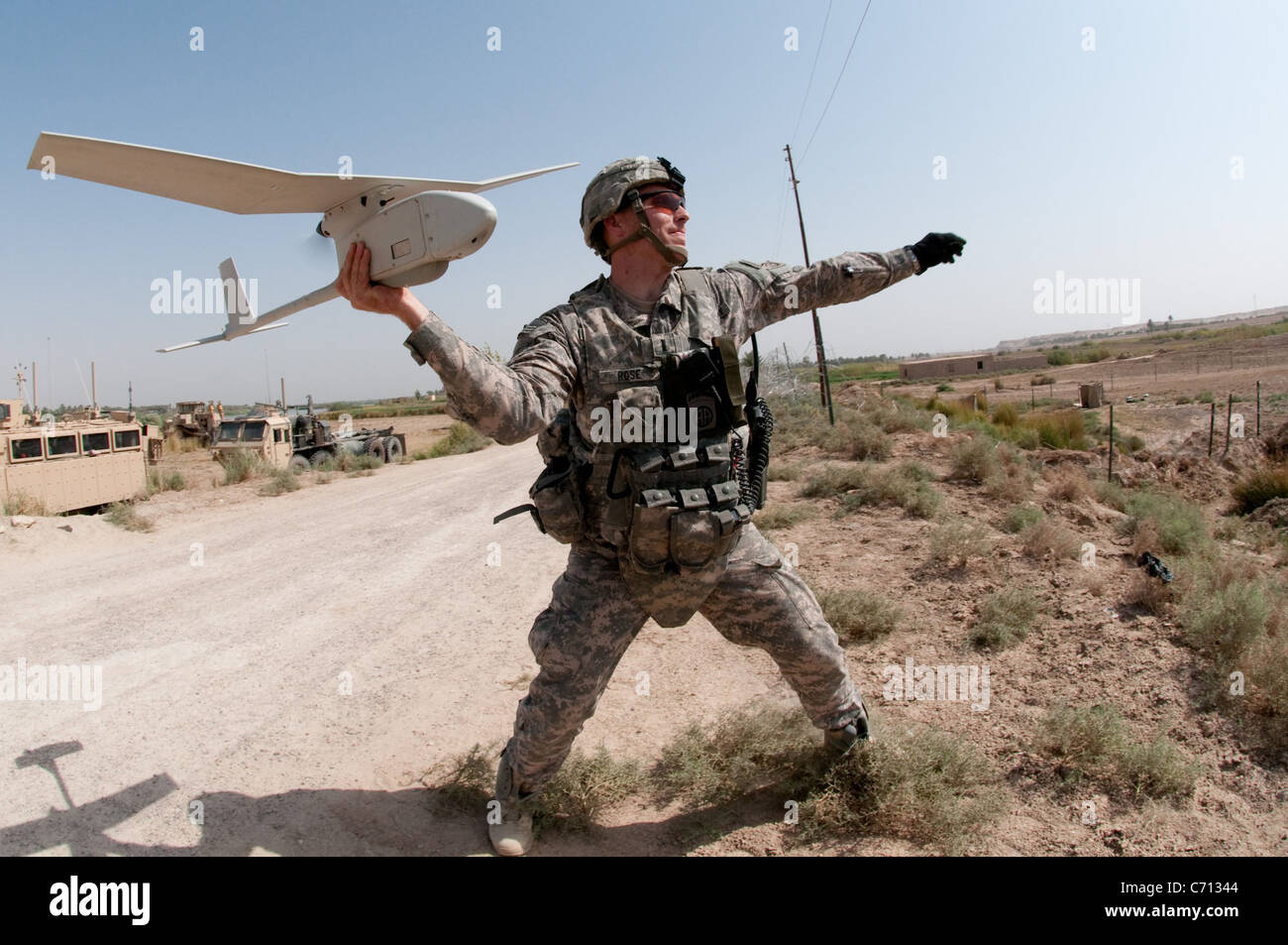 U.S. Army 1st Lt. Steven Rose launches an RQ-11 Raven unmanned aerial vehicle near a new highway bridge project along the Euphrates River north of Al Taqqadum, Iraq, on Oct. 9, 2009. Rose is assigned to Charlie Company, 1st Battalion, 504th Parachute Infantry Regiment, 1st Brigade Combat Team, 82nd Airborne Division which is assisting Iraqi police in providing security for the work site. DoD photo by Spc. Michael J. MacLeod, U.S. Army. (Released) Stock Photo