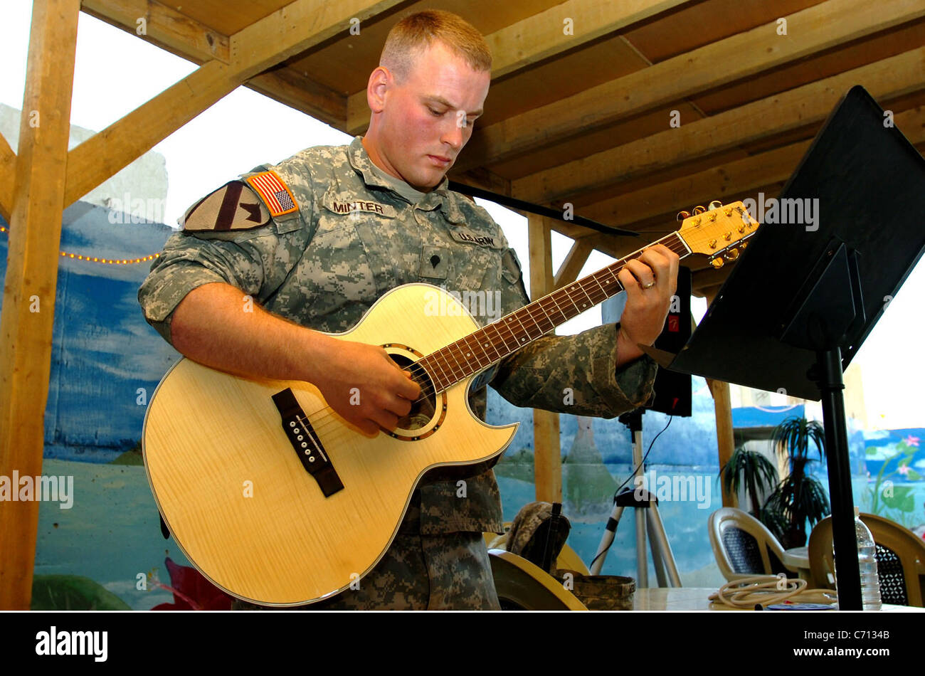 Waxahachie, Texas, native Spc. Thomas Minter, a wheeled vehicle mechanic for 615th Aviation Support Battalion, 1st Air Cavalry Brigade, 1st Cavalry Division, plays the guitar for the special music during a 9/11 prayer breakfast at Camp Taji, Iraq, Sept. 11. Among the special guests was Traverse City, Mich., native Col. Dan Shanahan, the commander of 1st ACB. (U.S. Army Photo by Spc. Nathan Hoskins, 1st ACB, 1st Cav. Div. Public Affairs) Stock Photo
