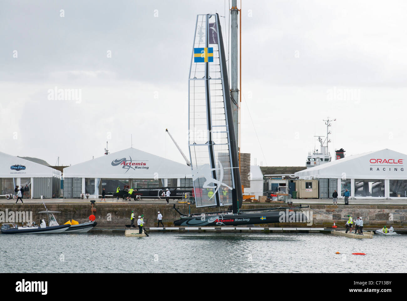 Artemis Racing AC45 catamaran being craned into the water at Millbay race village for the America's Cup World Series in Plymouth Stock Photo