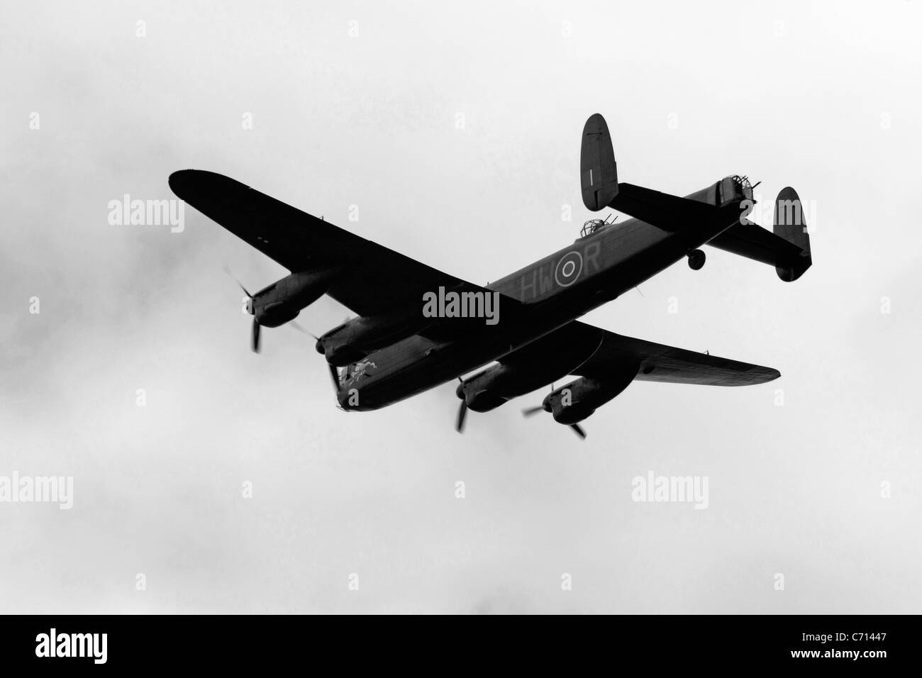 B/W WW2 British RAF Avro Lancaster Bomber Plane on a pass over an
