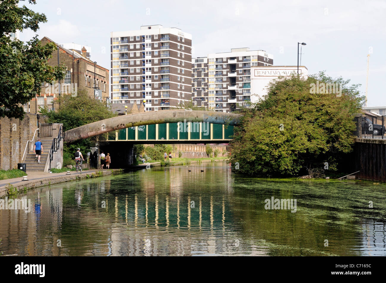 Bridge over the Regent's Canal with people on towpath and flats behind