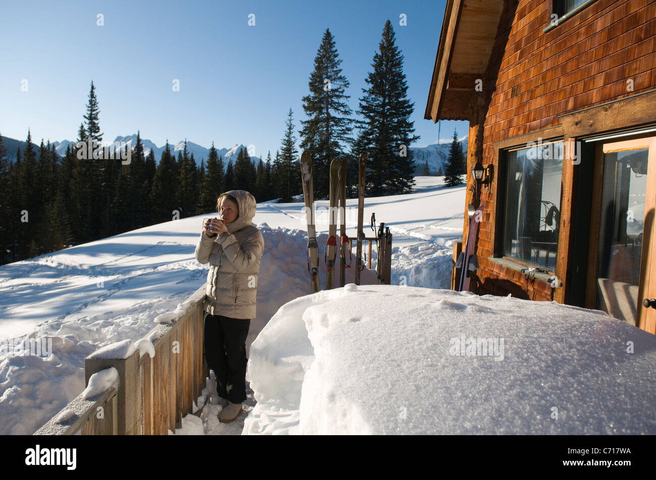 Woman Drinking Hot Drink On Deck Of Cabin Molas Pass Silverton