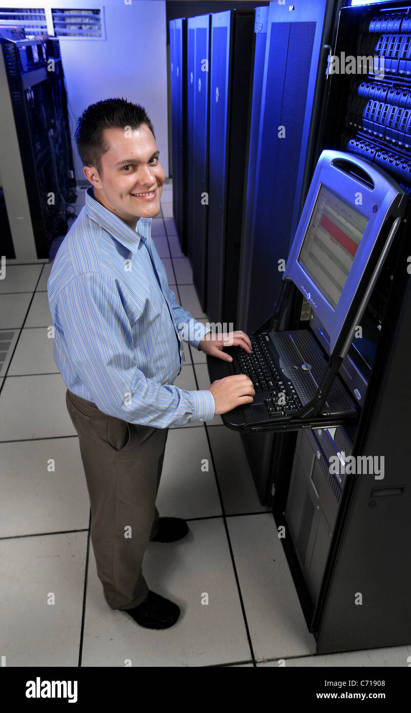 Information Technology person works with servers in a server room. Stock Photo