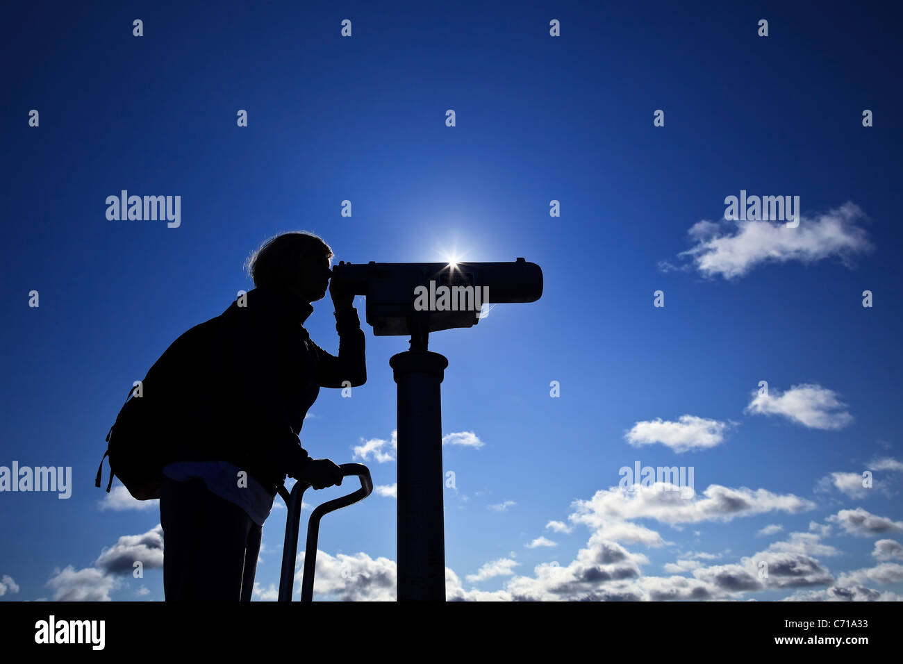 Woman looking through telescope, silhouette. Stock Photo
