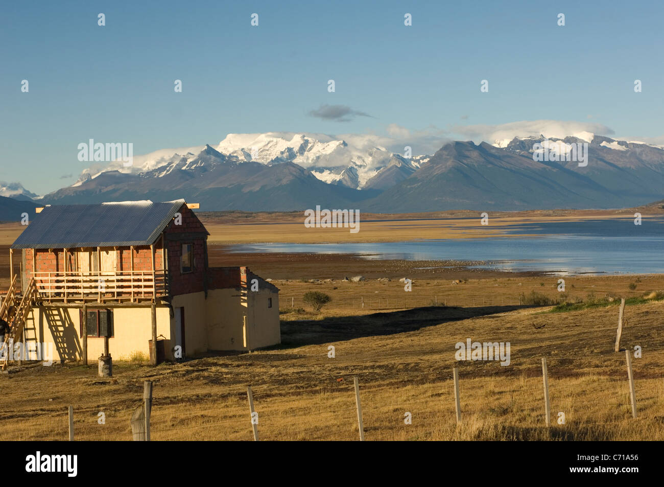 A typical gaucho dwelling looks over Lago Argentino towards the mountains surrounding the Perito Moreno glacier in Argentina. Stock Photo