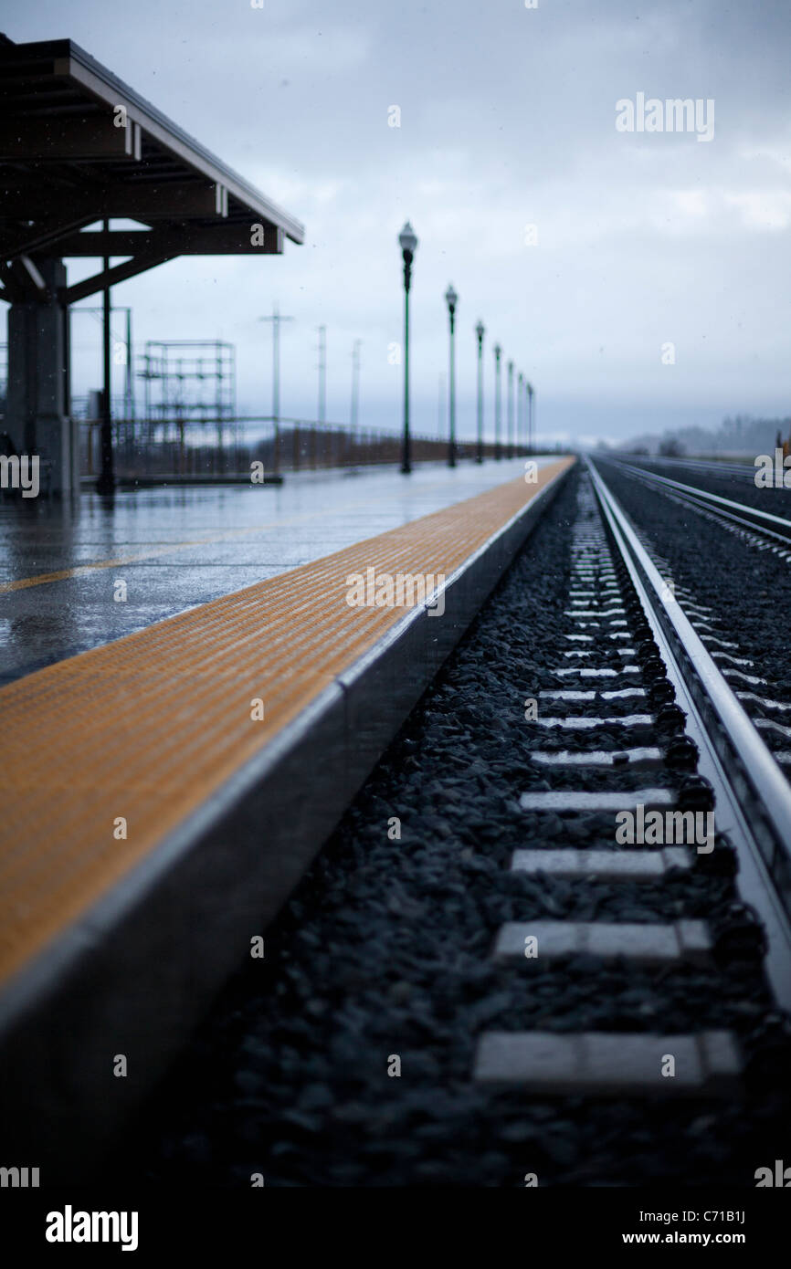 An empty train station seen through snow and winter skies. Stock Photo