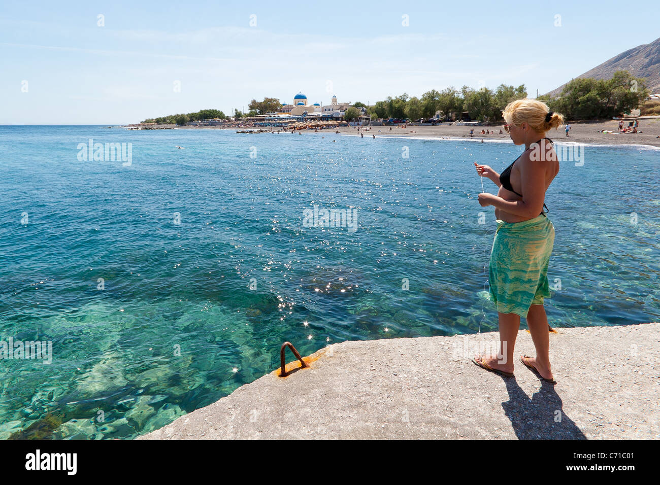 Girl Fishing, Perissa, Santorini Stock Photo