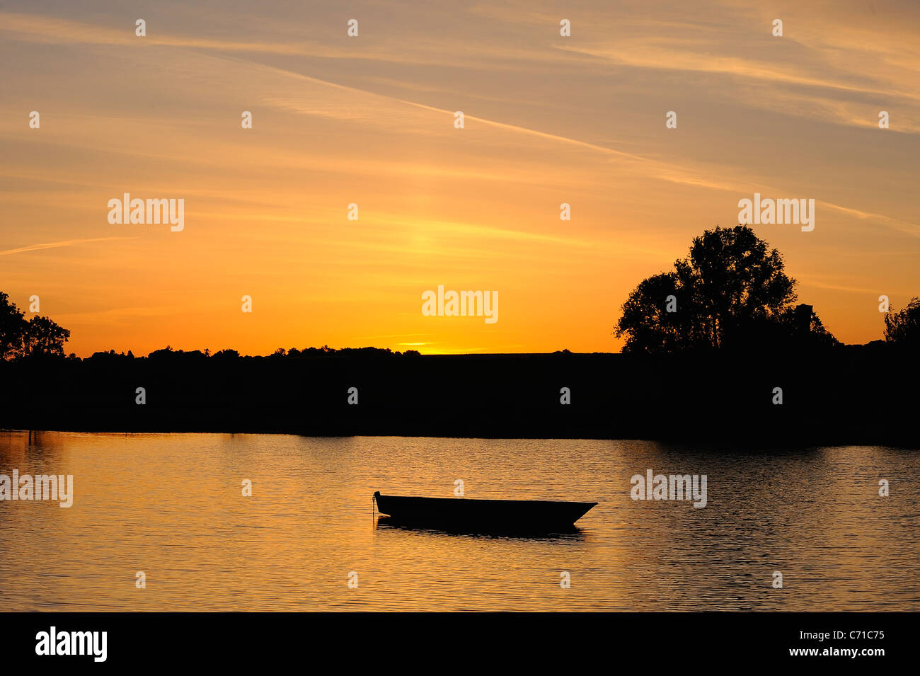 Small wood boat on a lake at sunrise in Chenac Saint Seurin d'Uzet, Charente Maritime, west of France Stock Photo