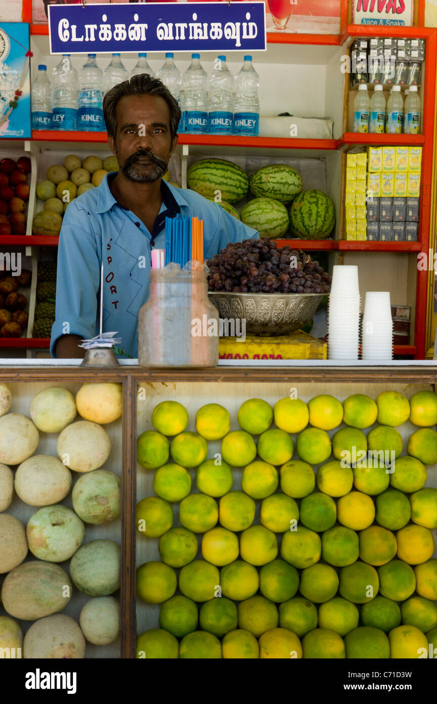 Employees at a fresh fruit juice stall on the streets of Madurai, Tamil Nadu state, India Stock