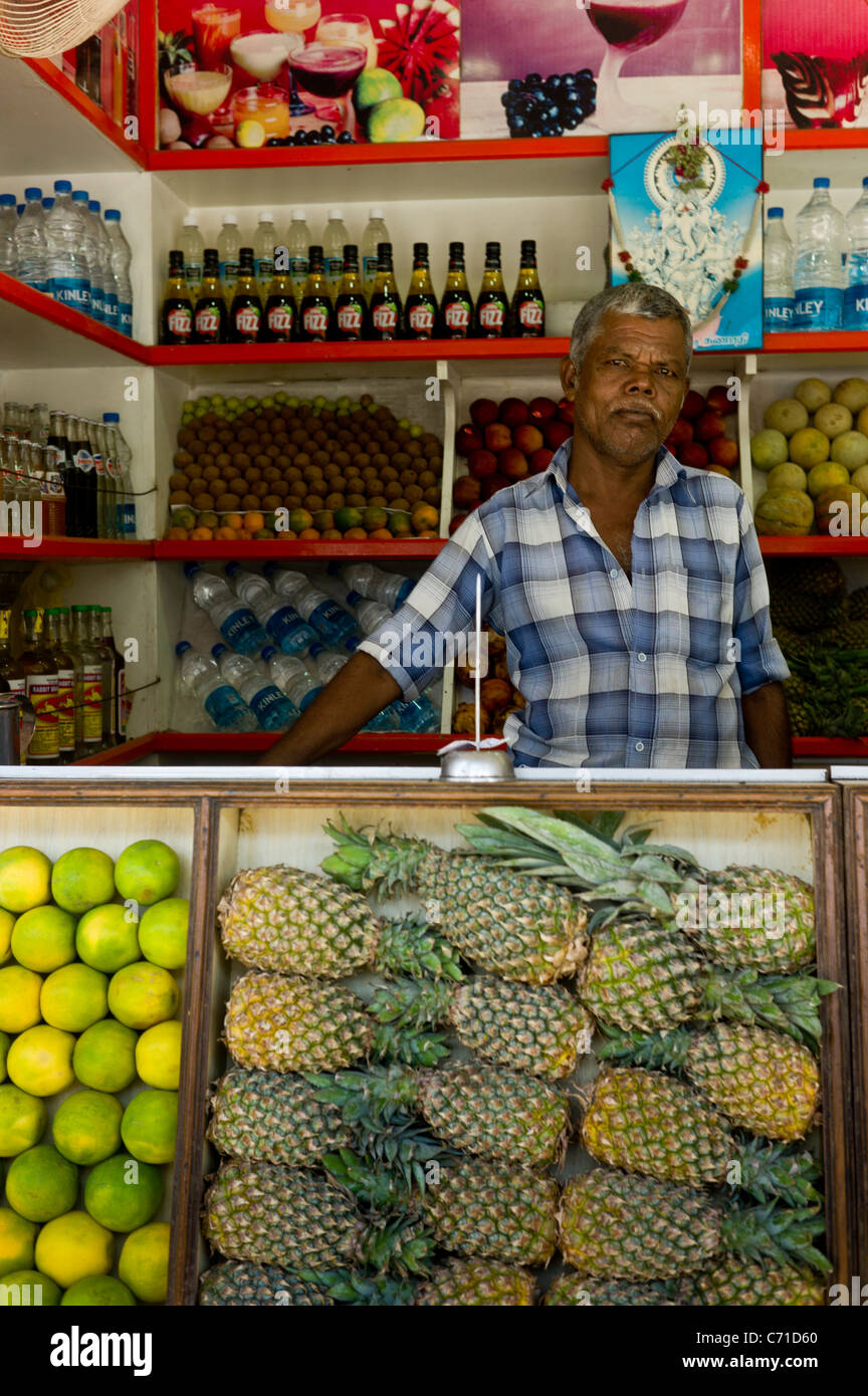 Employees at a fresh fruit juice stall on the streets of Madurai, Tamil Nadu state, India. Stock Photo