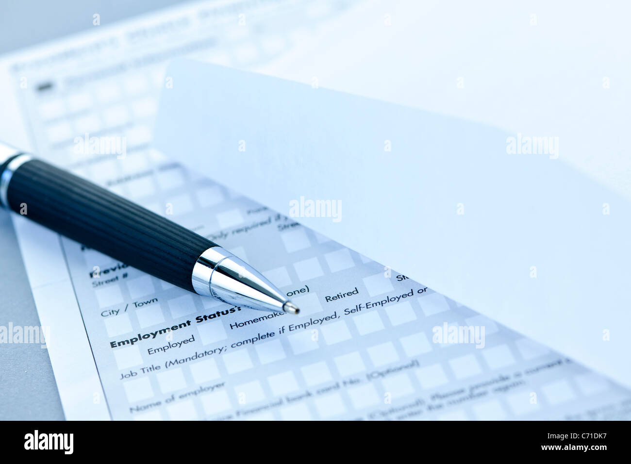 Blank credit application form with envelope and pen close up stock