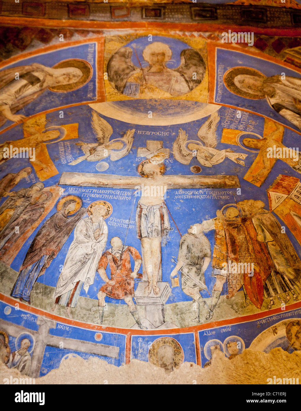 Crucified Christ on a Domed Ceiling. A damaged painting of the crucifiction of Christ on the front half dome of a Goreme church Stock Photo