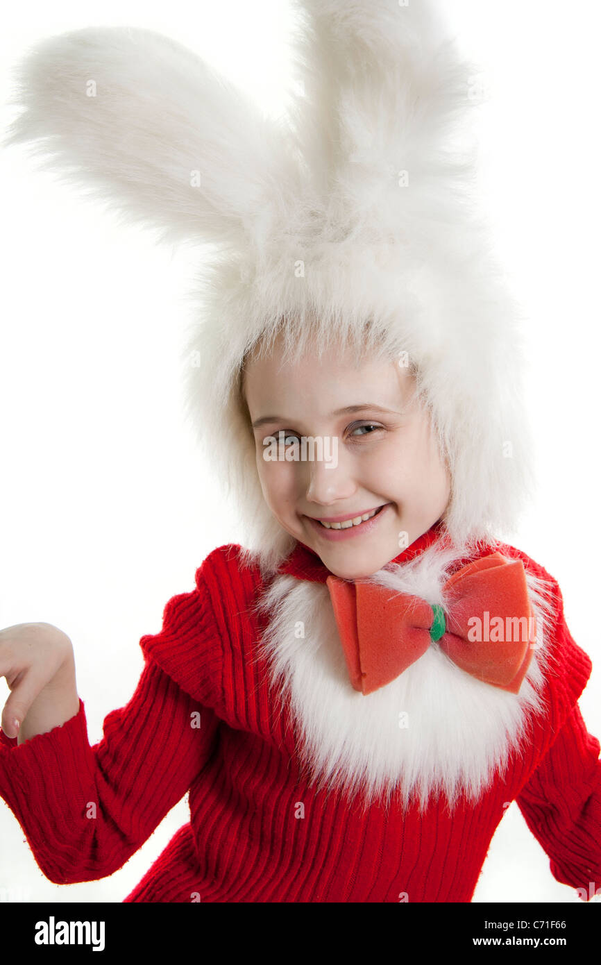 Сhild in a white downy bunny costume. Stock Photo