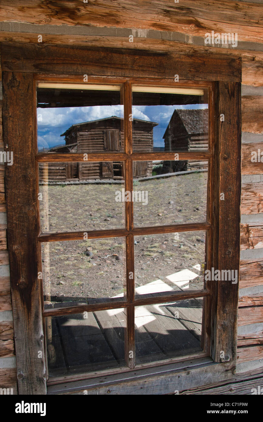 Reflection in window of antique building in Old Trail Town, Cody, Wyoming. Stock Photo