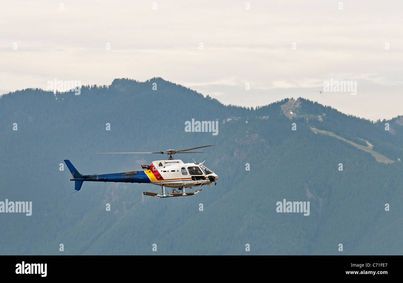 A Royal Canadian Mounted Police (RCMP) helicopter on patrol, Vancouver, Canada. Stock Photo