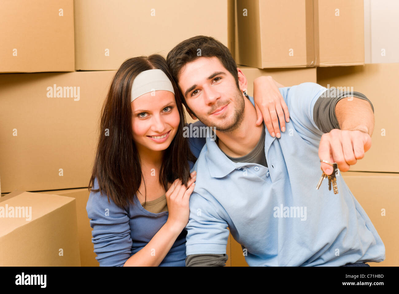 Moving into new home young happy couple holding house keys Stock Photo ...