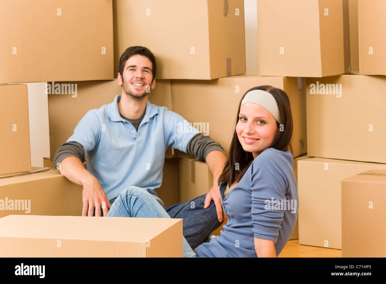 Moving into new home young happy couple sitting on floor Stock Photo ...