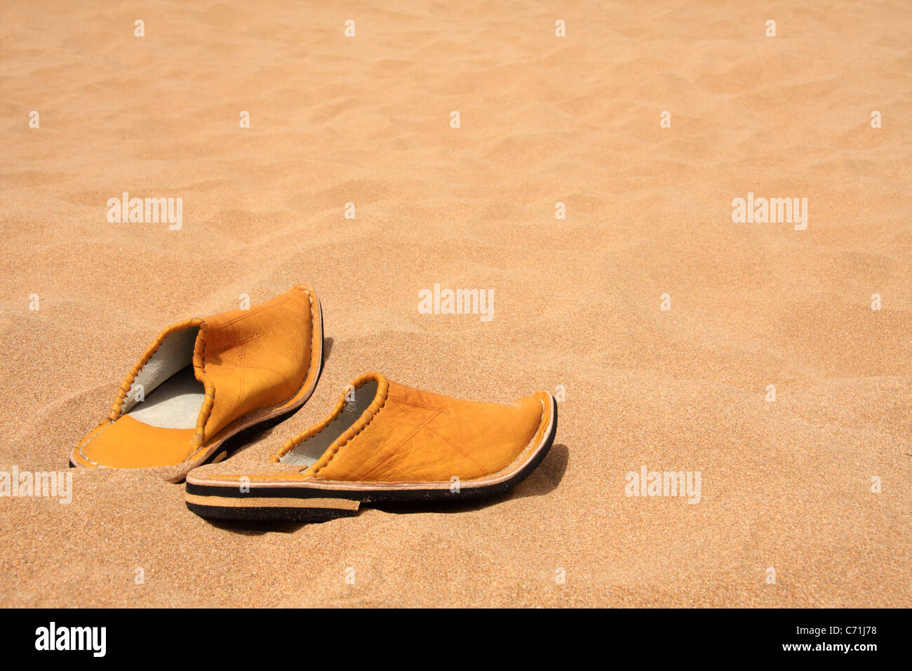 Traditional Moroccan slippers shoes (babouches) on a beach in Morocco with copy space, Morocco, North Africa Stock Photo