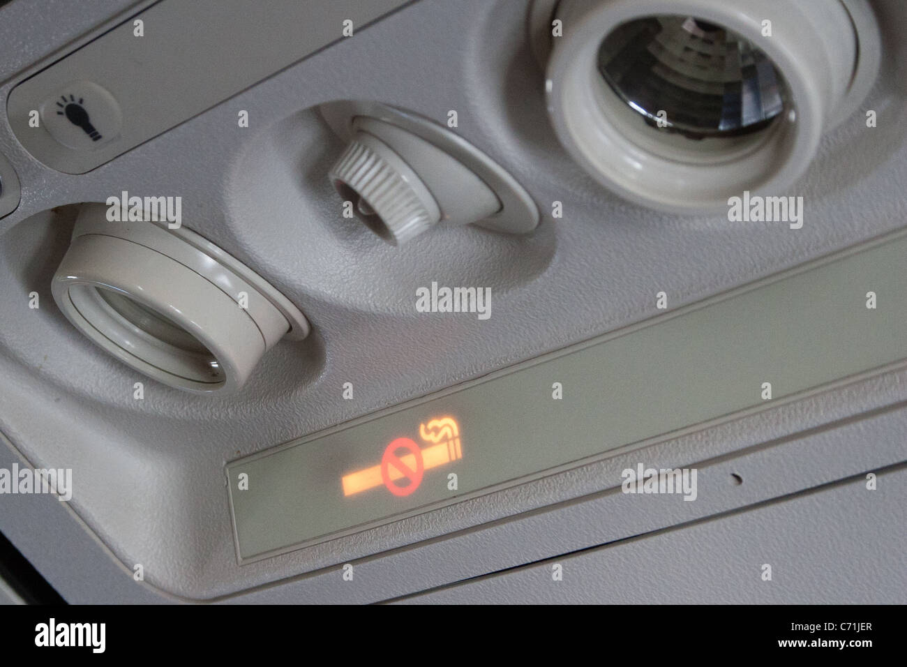 Aircraft over seat light and air vent Stock Photo Alamy
