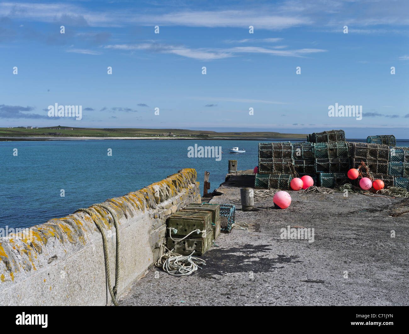 dh South Wick pier PAPA WESTRAY ISLAND ORKNEY ISLES Creels and wooden fish boxes remote harbour scotland Stock Photo
