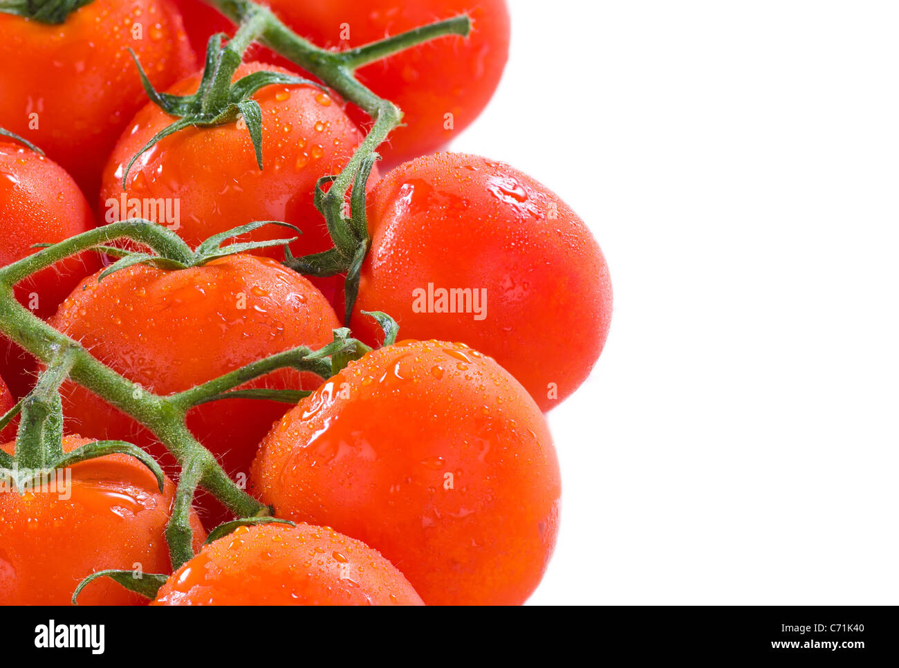 Tomatoes on the vine, a food background Stock Photo - Alamy