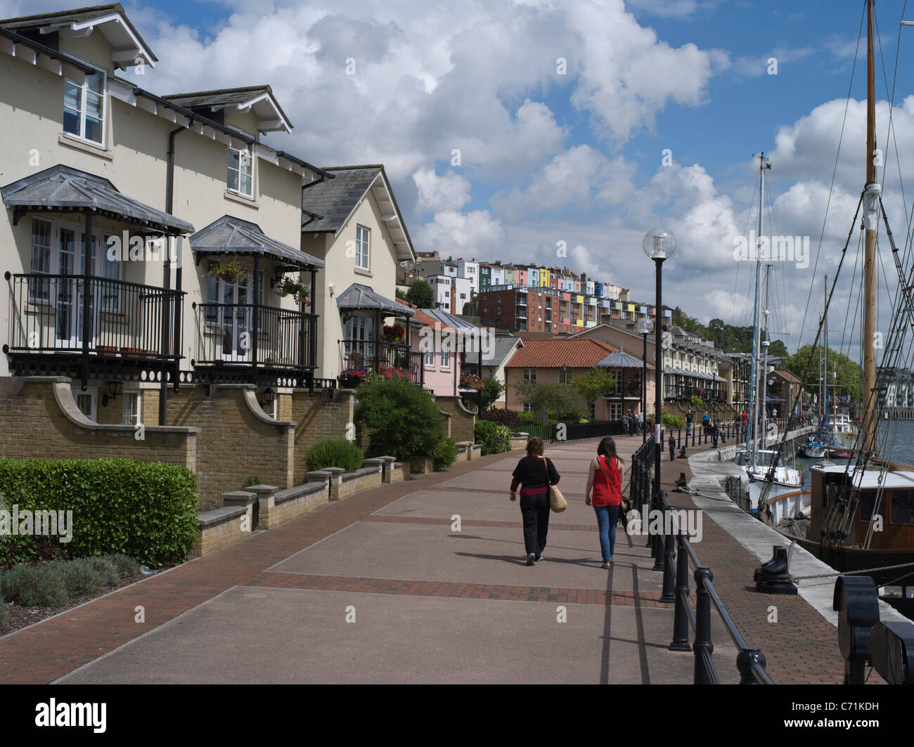 dh  HOTWELLS BRISTOL New houses two people walking along harbour waterfront england house modern home uk residential building street luxury exterior Stock Photo