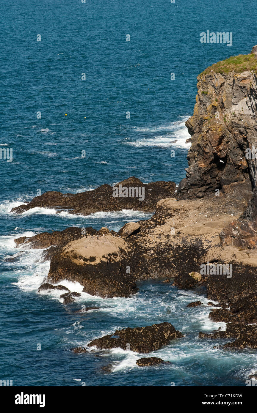 Waves crashing against rocks on the Cornish coast in England. Stock Photo