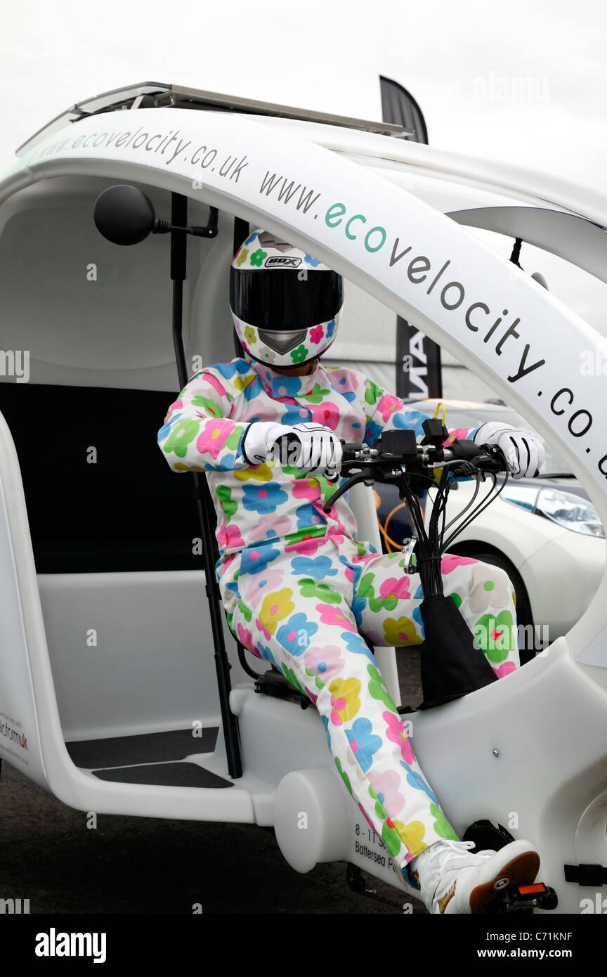 The green Stig, driving an electrically assisted bycicle-powered rickshaw at ecovelocity. the low-carbon  motor show Stock Photo