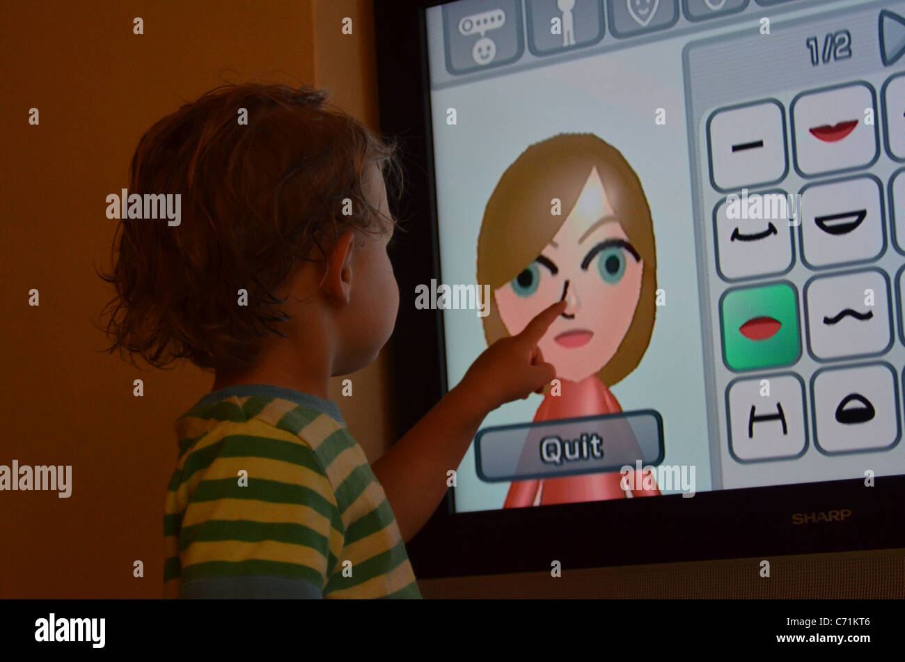 Small child points to character avatar in Nintendo Wii game Stock Photo -  Alamy