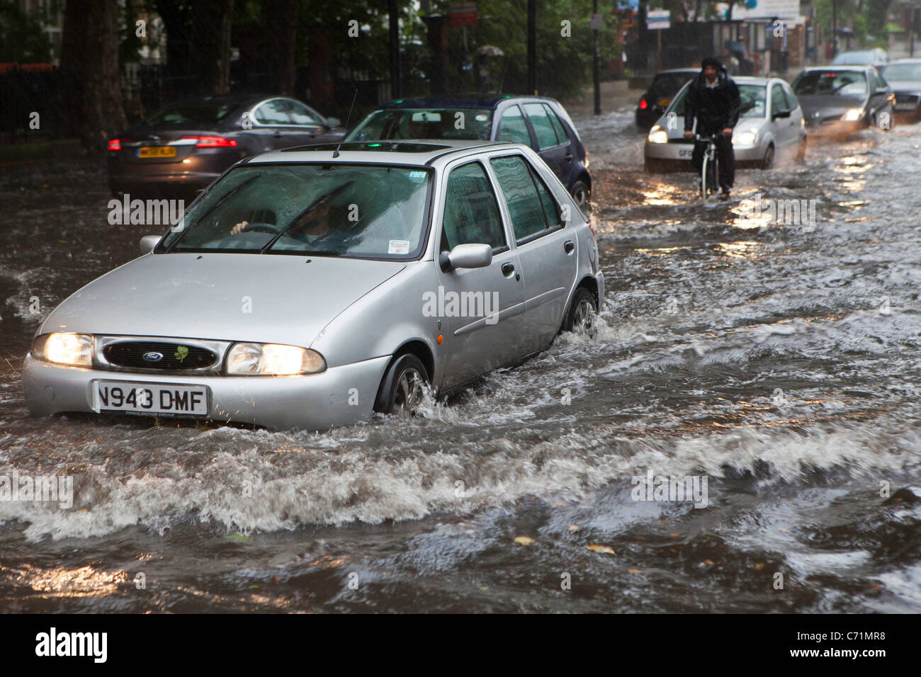 Heavy rain causes flash flooding in Stoke Newington, London. Traffic struggled as torrential rain flooded the area Stock Photo