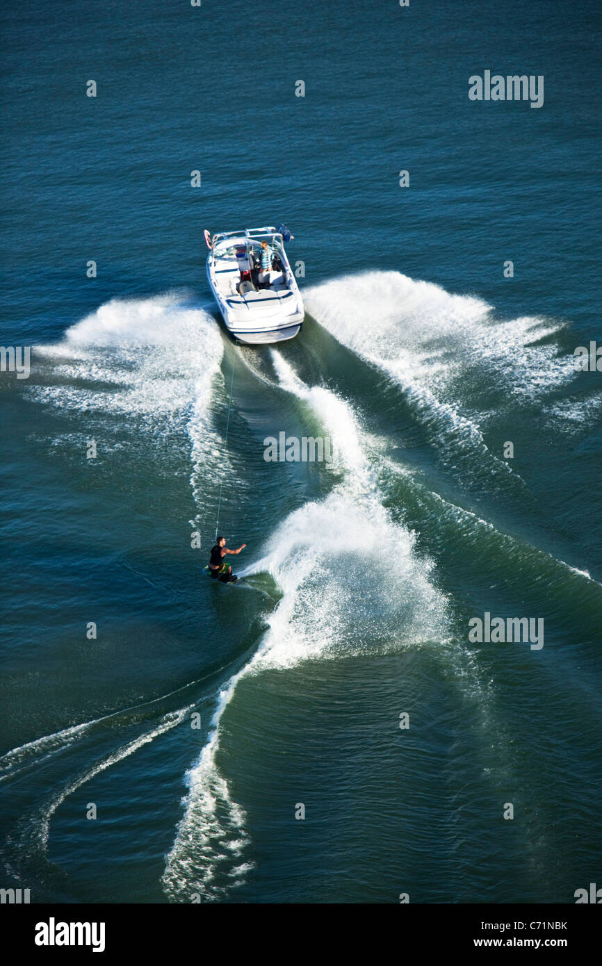 A athletic wakeboarder carves and slashes on a calm day in Idaho. Shot from above. Stock Photo