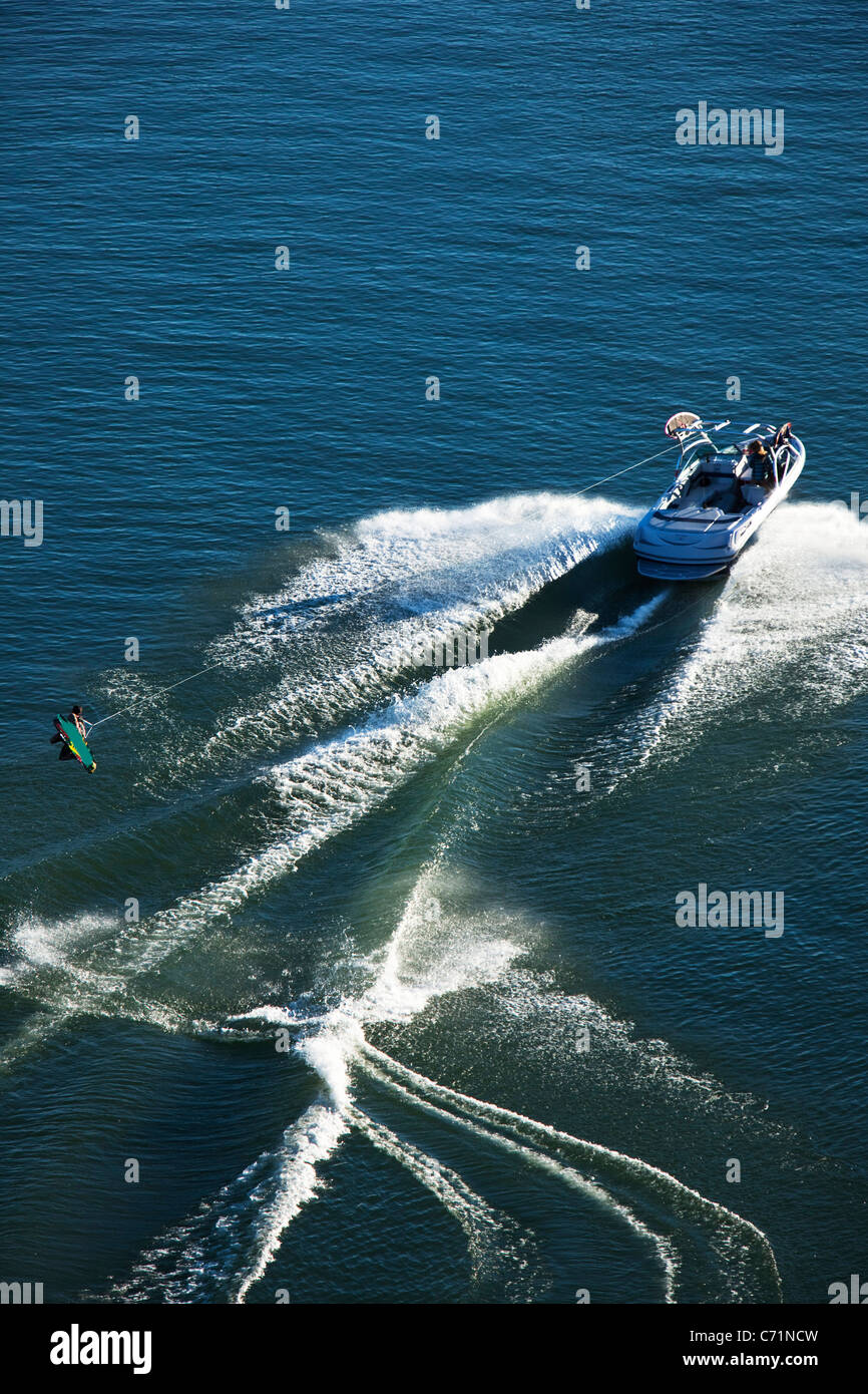 A athletic wakeboarder jumps the wake going huge on a calm day in Idaho. Stock Photo