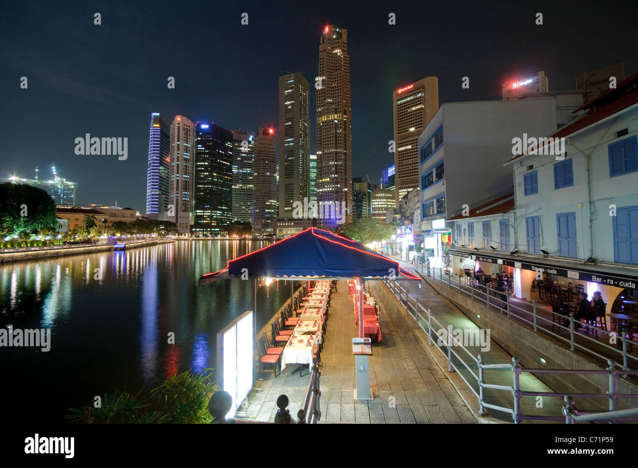 Restaurants at Boat Quay at night, skyscrapers of financial district