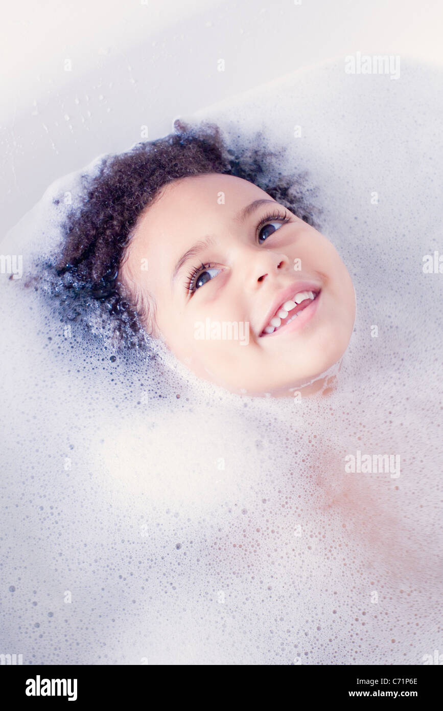 Little girl taking bath, head surrounded by soap sud Stock Photo Alamy