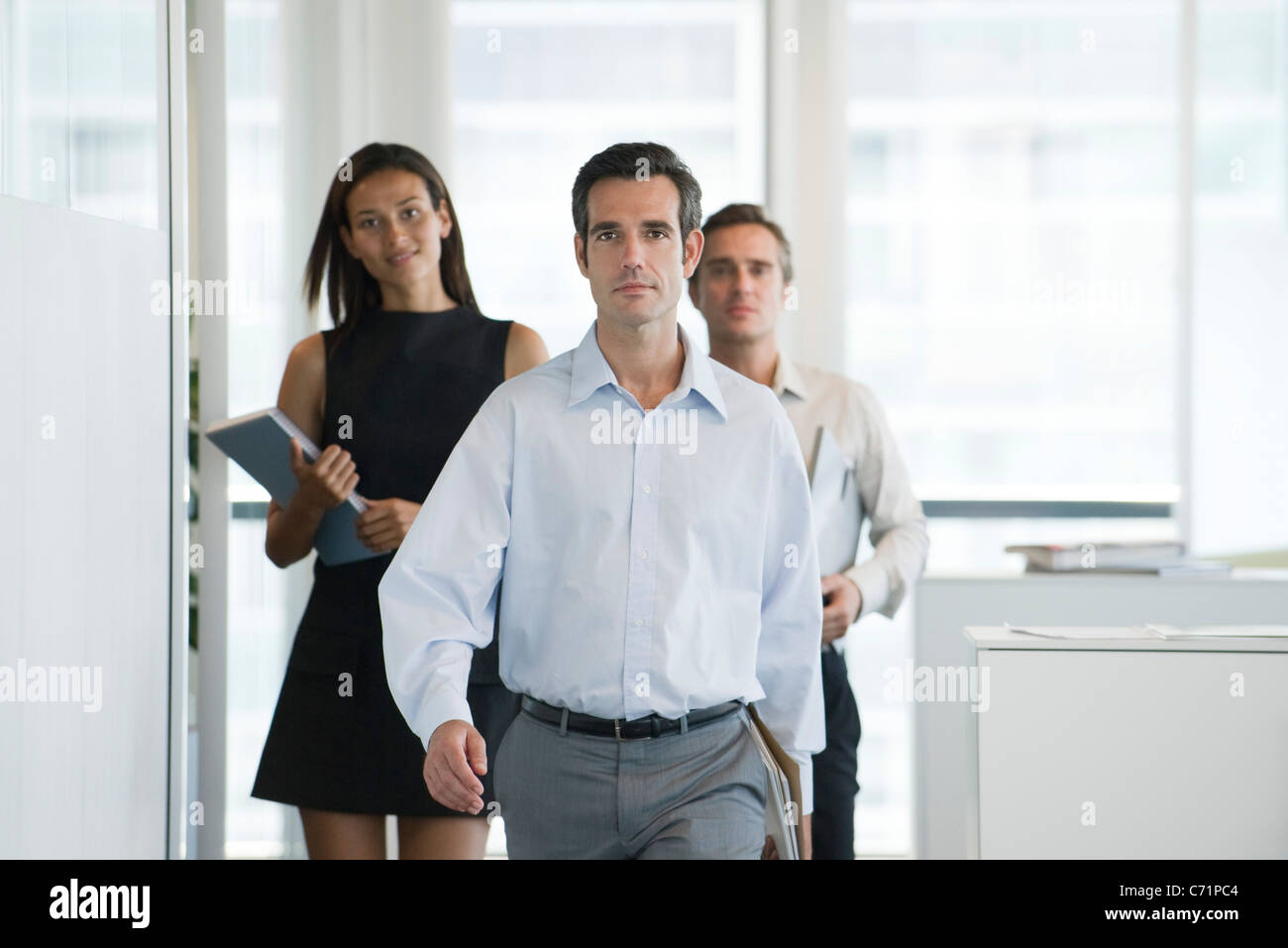Executives walking in office Stock Photo
