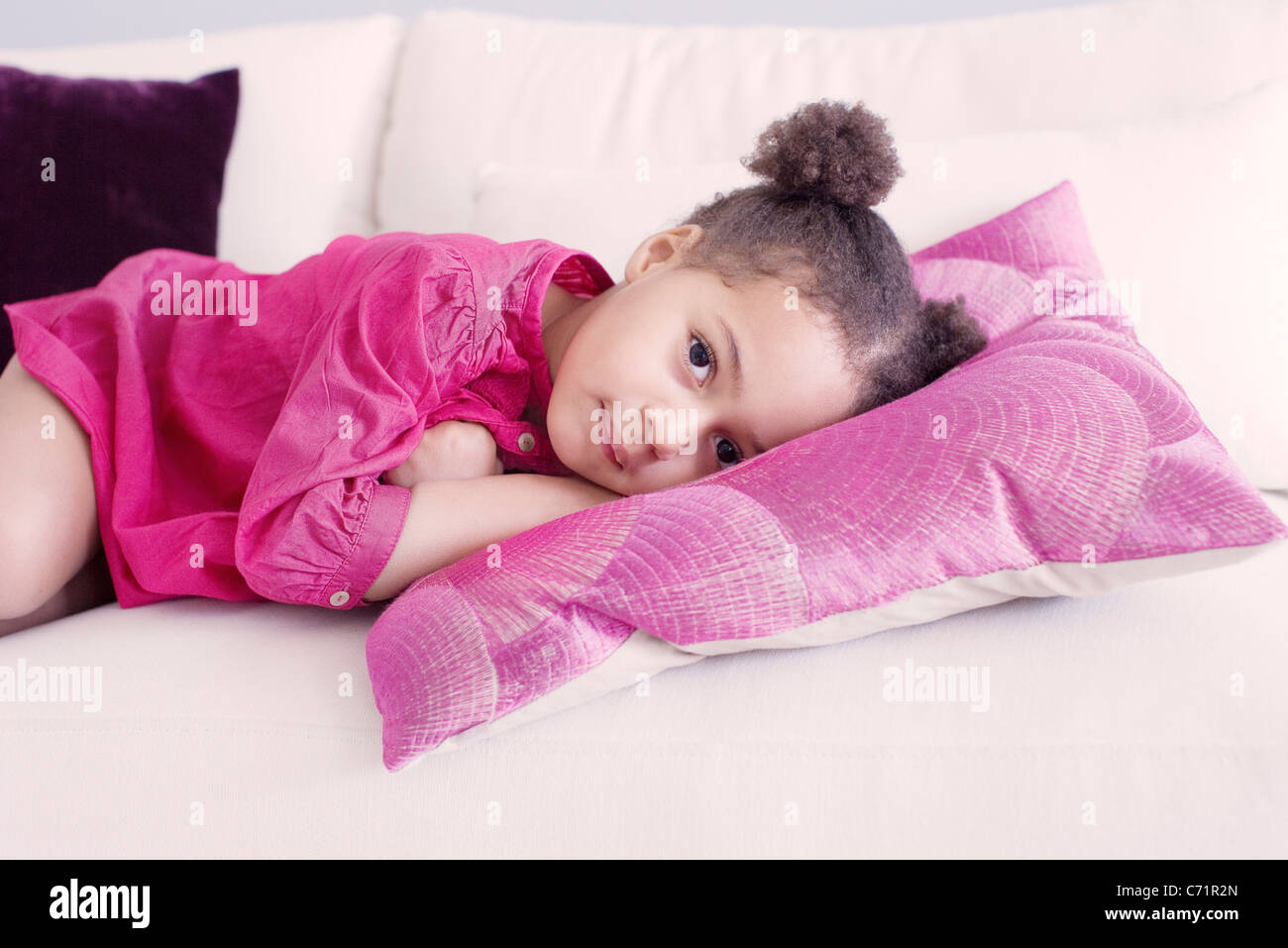 Little girl lying on couch Stock Photo