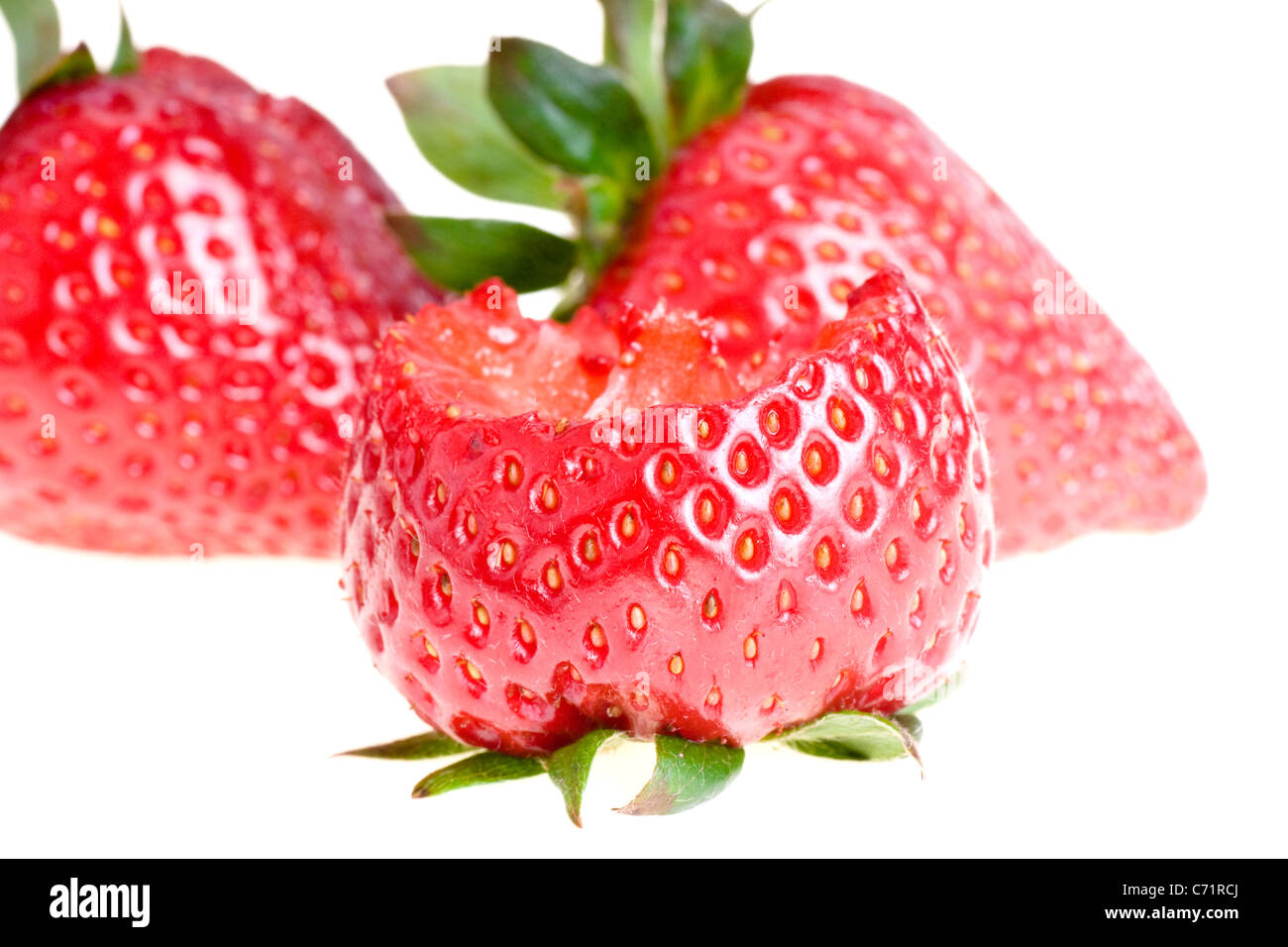 Bitten strawberry, isolated on white Stock Photo