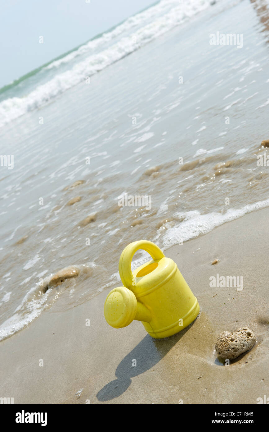 Toy watering can on beach Stock Photo Alamy