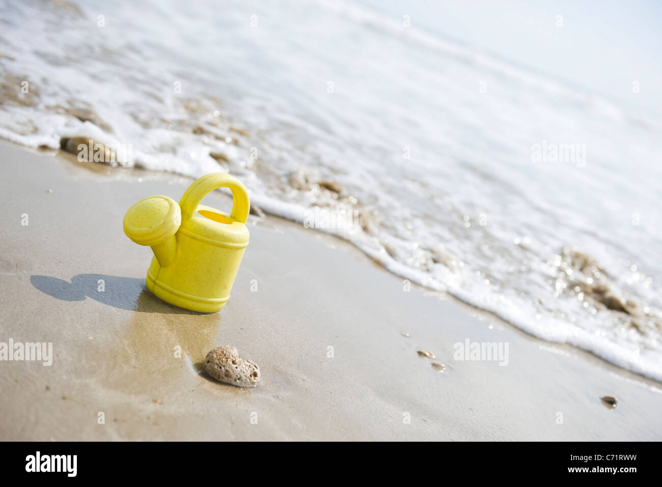 Toy watering can on beach Stock Photo Alamy